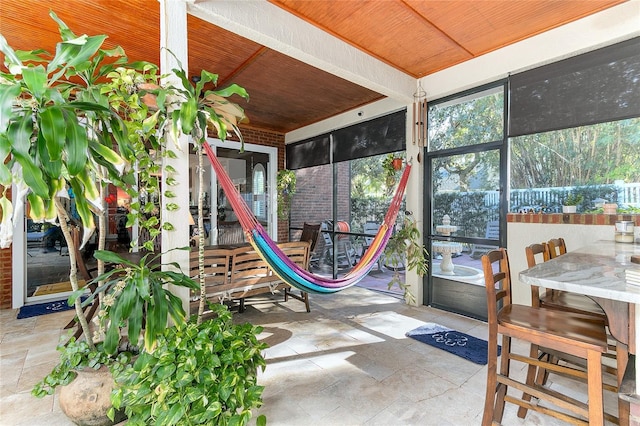 sunroom featuring wood ceiling