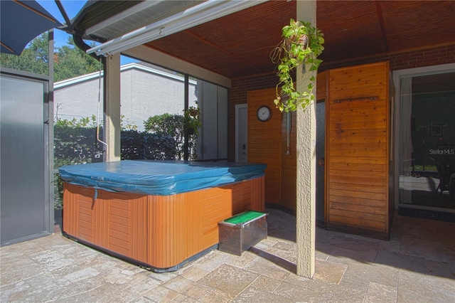 view of patio / terrace with a hot tub