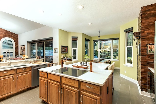 kitchen with black electric stovetop, a kitchen island, light countertops, brown cabinets, and dishwasher