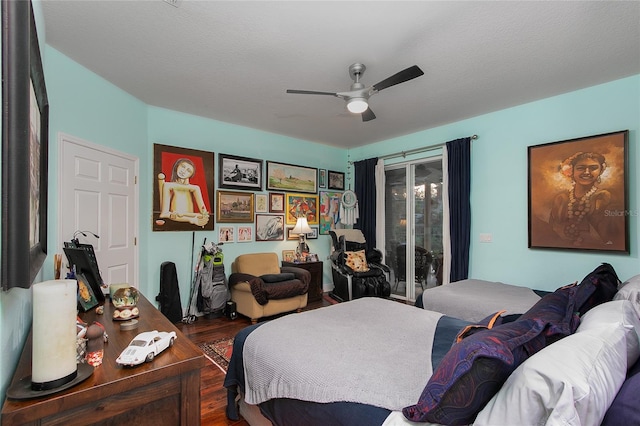 bedroom with dark wood-type flooring, access to exterior, a textured ceiling, and a ceiling fan