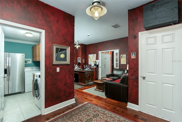 interior space with visible vents, light wood-type flooring, cabinet space, and baseboards