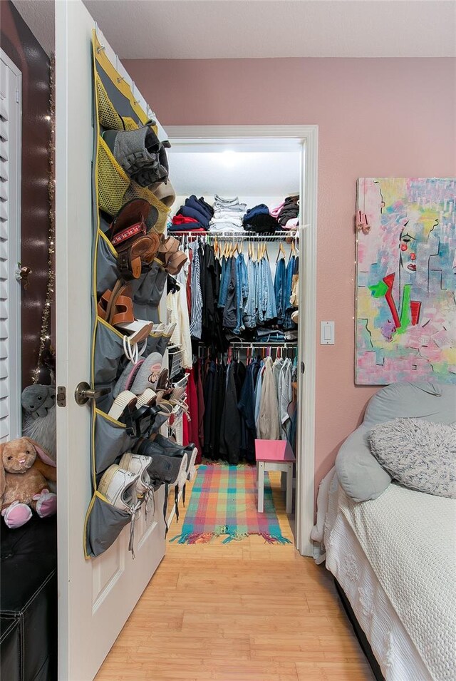 walk in closet featuring wood finished floors