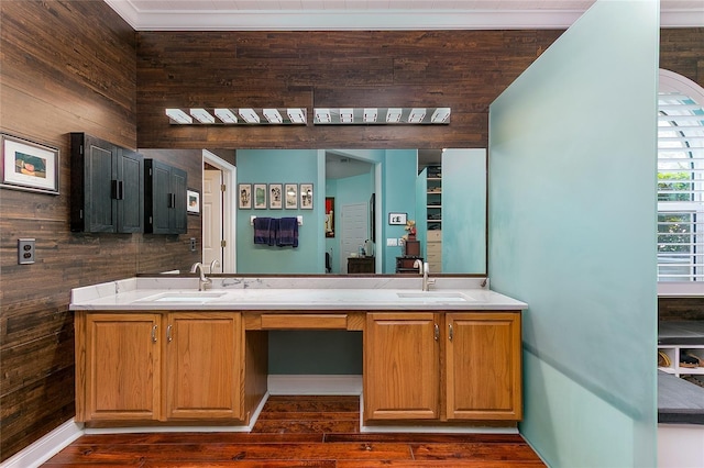 full bath with double vanity, wood finished floors, and a sink