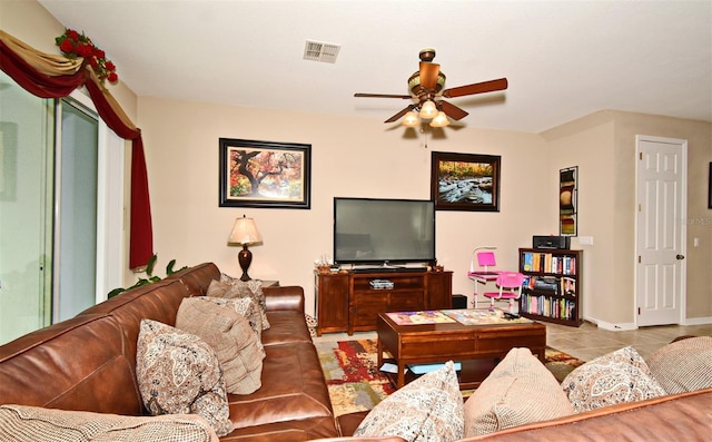 tiled living room with ceiling fan