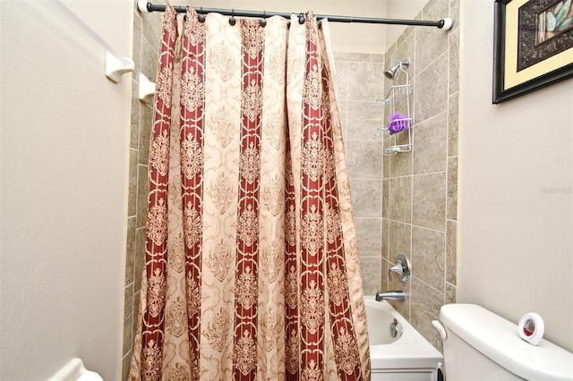 bathroom with shower / bath combination with curtain and toilet