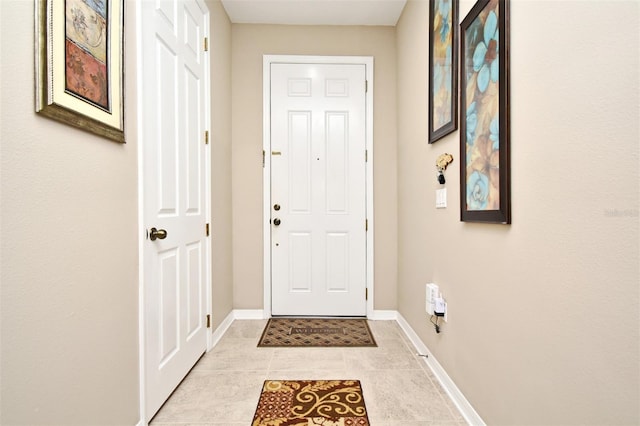 doorway with light tile patterned flooring