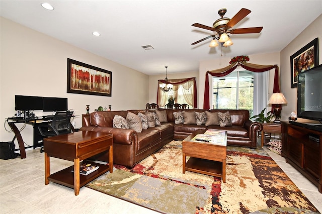 living room with ceiling fan with notable chandelier