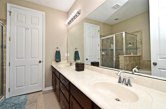 bathroom with shower with separate bathtub, tile patterned floors, and vanity