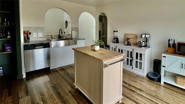 bar with wood counters, white cabinets, sink, hardwood / wood-style flooring, and dishwasher