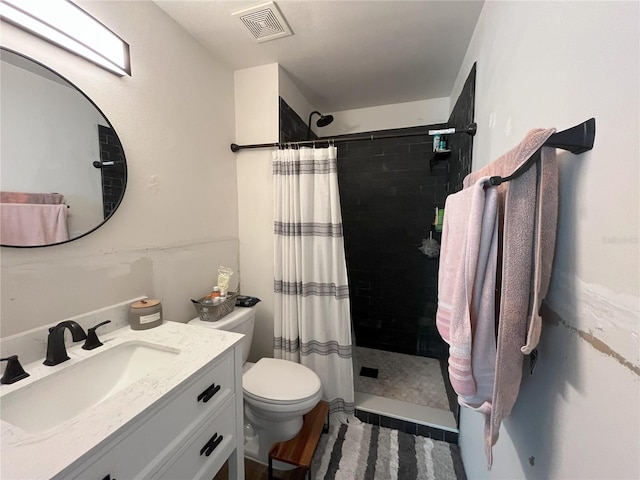 bathroom with vanity, toilet, and walk in shower