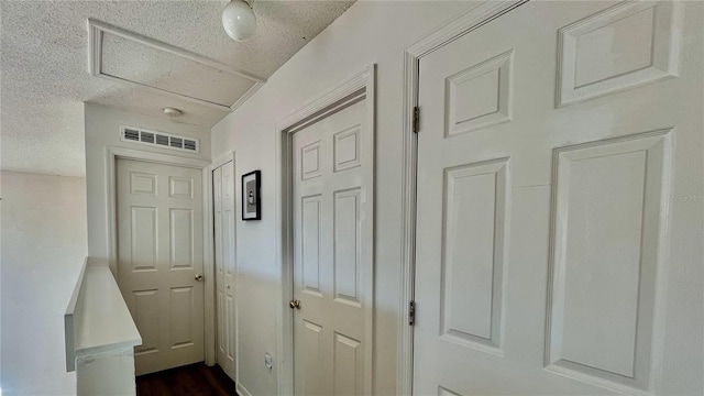 hallway with a textured ceiling