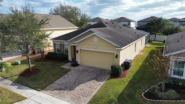 view of front of property featuring a front lawn and a garage