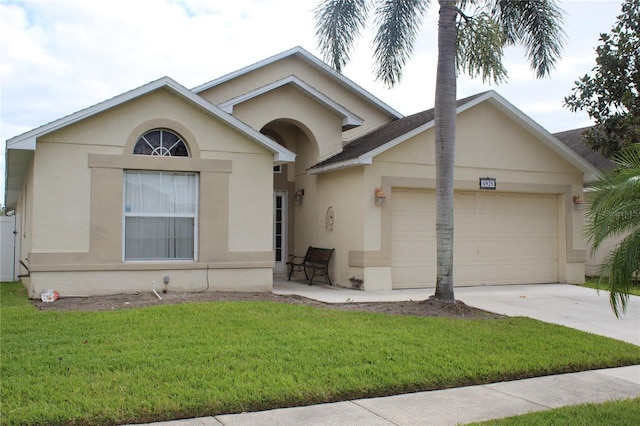 ranch-style house featuring a garage and a front yard