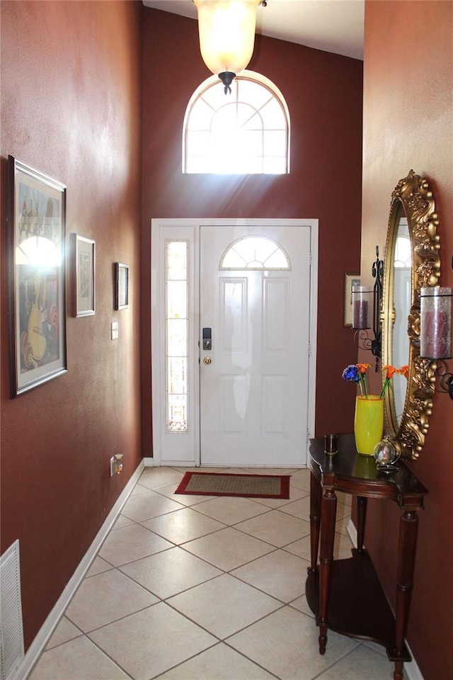 tiled entrance foyer with high vaulted ceiling