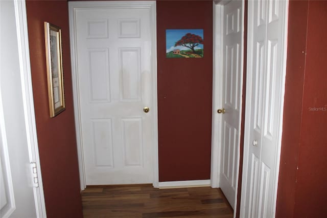 corridor with dark wood-type flooring