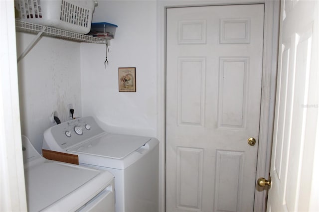 laundry area with independent washer and dryer