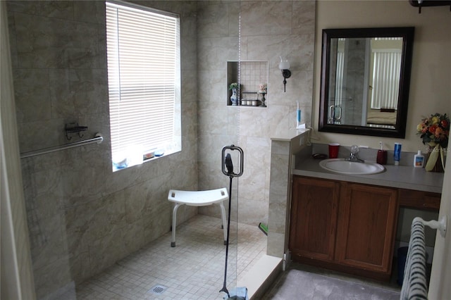 bathroom featuring a shower, tile patterned flooring, and vanity