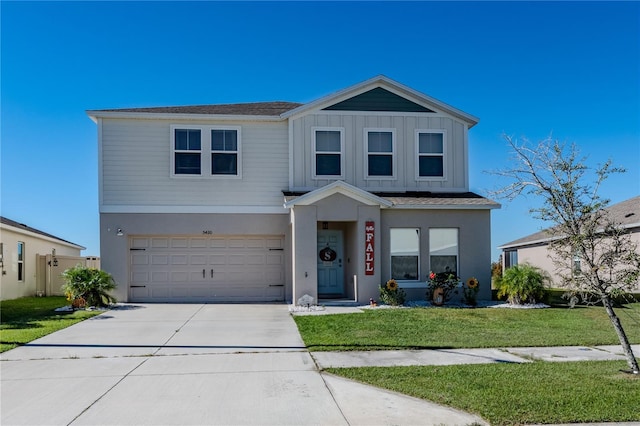 view of front of property featuring a garage and a front yard