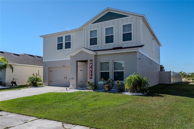 view of front of house with a front yard and a garage