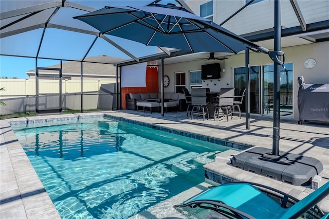 view of pool featuring a lanai, an outdoor living space, ceiling fan, and a patio area