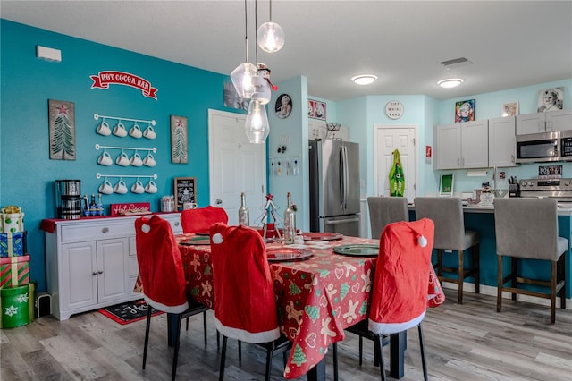 dining area with light hardwood / wood-style flooring