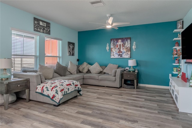 living room with ceiling fan and light wood-type flooring