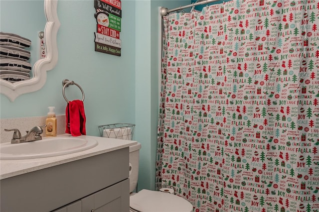 bathroom with a shower with curtain, vanity, and toilet