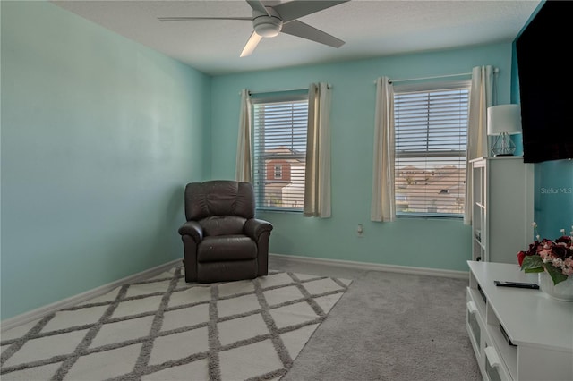 sitting room with light carpet, plenty of natural light, and ceiling fan