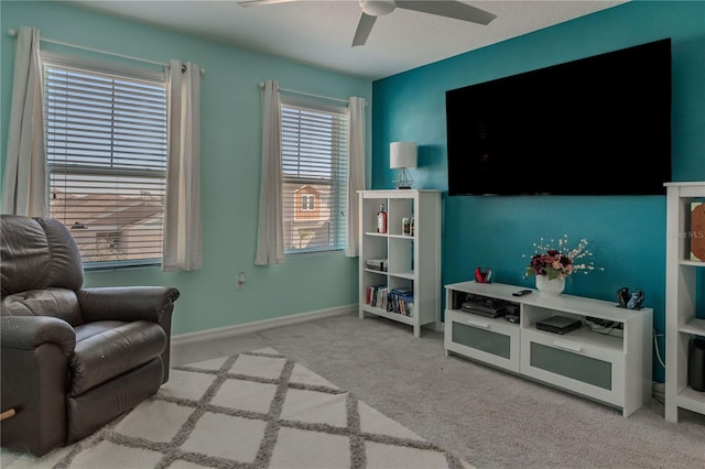 living area featuring ceiling fan and light colored carpet