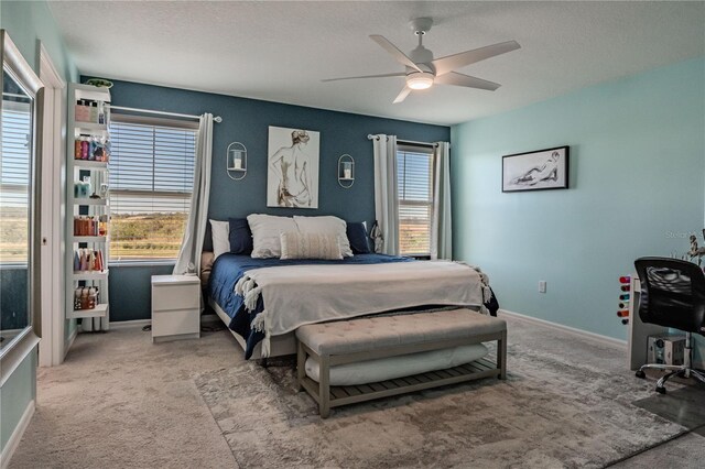 bedroom featuring carpet, a textured ceiling, and ceiling fan