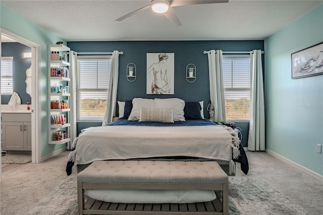 carpeted bedroom with ceiling fan, a textured ceiling, and connected bathroom