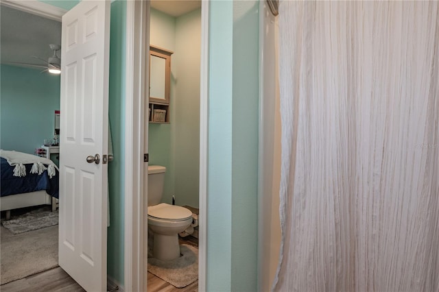 bathroom with ceiling fan, hardwood / wood-style floors, and toilet