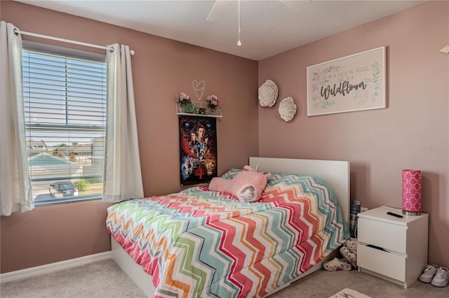 carpeted bedroom with ceiling fan and multiple windows