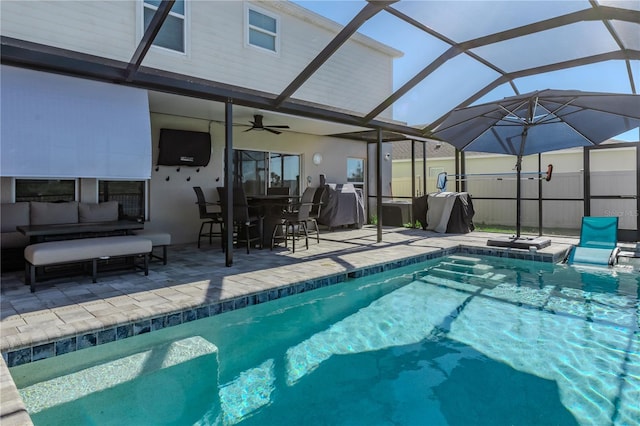 view of swimming pool with glass enclosure, a patio area, and an outdoor hangout area