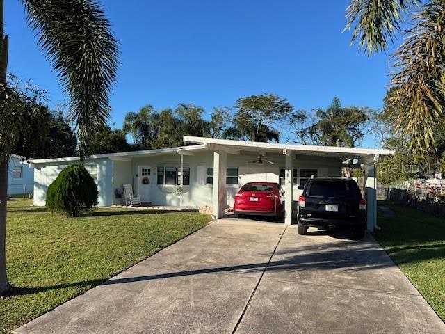 single story home featuring a front lawn and a carport