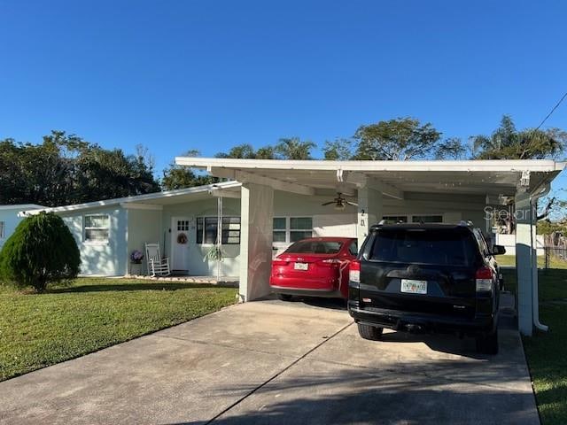 single story home with a front lawn and a carport