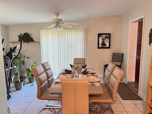 dining area featuring ceiling fan and light tile patterned floors