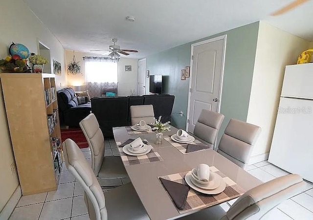 tiled dining area with ceiling fan