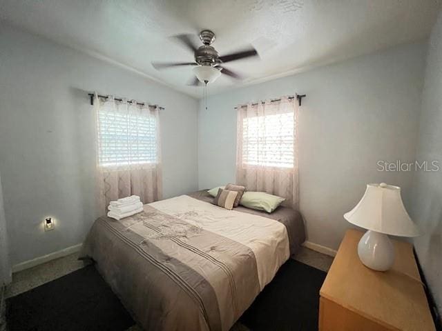 bedroom with ceiling fan and carpet floors