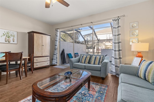 living room featuring dark hardwood / wood-style flooring and ceiling fan