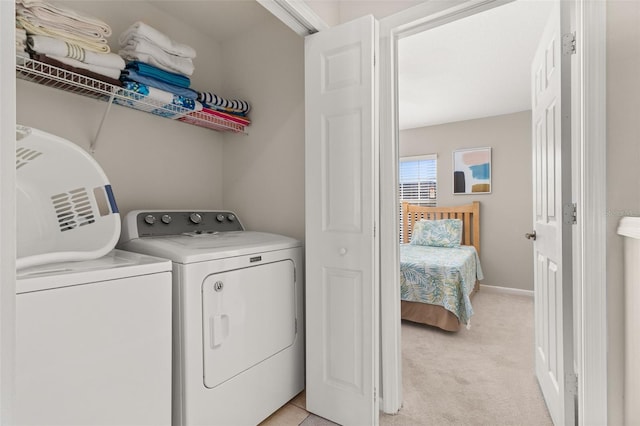 clothes washing area featuring washing machine and dryer and light carpet