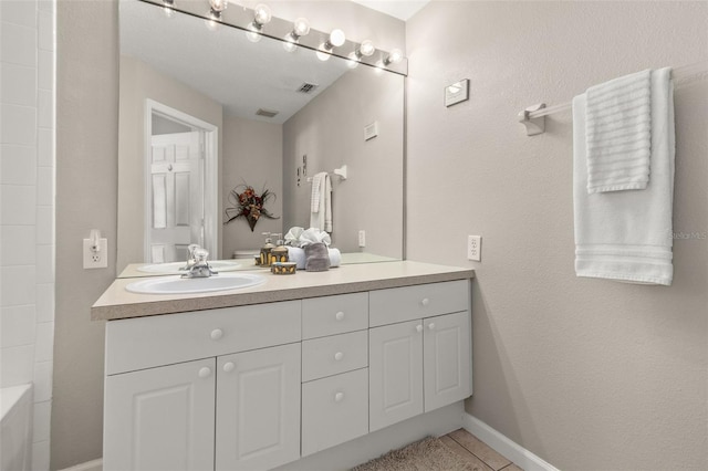 bathroom with tile patterned flooring and vanity