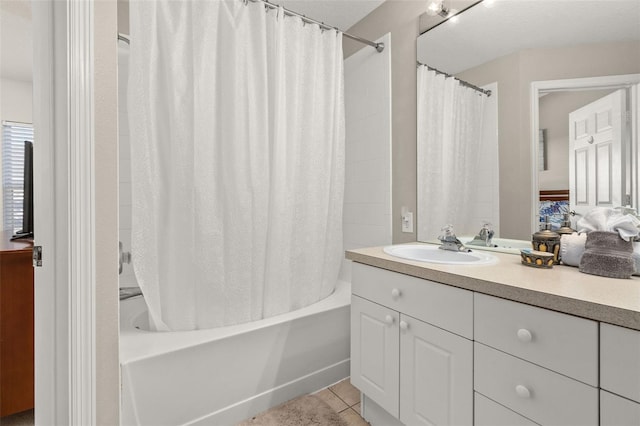 bathroom with tile patterned flooring, vanity, and shower / tub combo with curtain