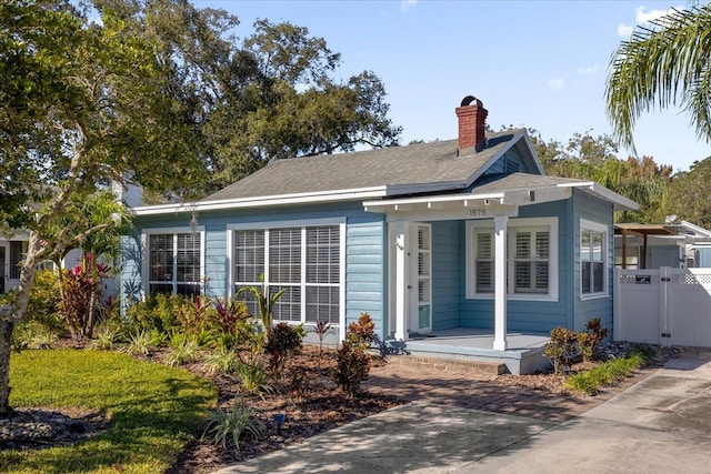 rear view of house featuring a porch