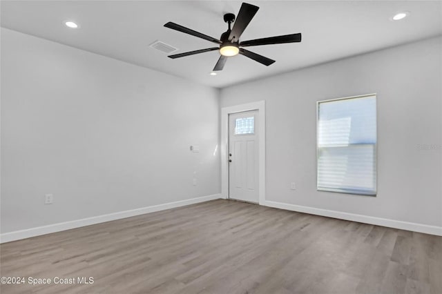 spare room featuring ceiling fan and light hardwood / wood-style flooring