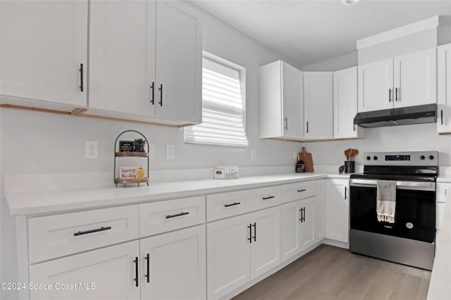 kitchen with white cabinets, light hardwood / wood-style floors, and stainless steel range with electric stovetop