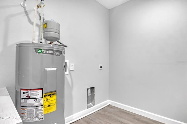 utility room featuring water heater