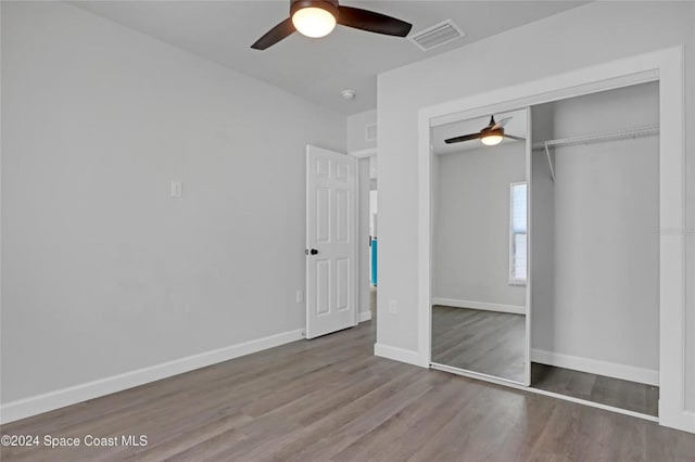 unfurnished bedroom with a closet, ceiling fan, and hardwood / wood-style floors