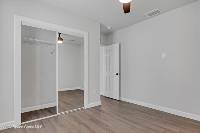 unfurnished bedroom featuring a closet, ceiling fan, and hardwood / wood-style floors