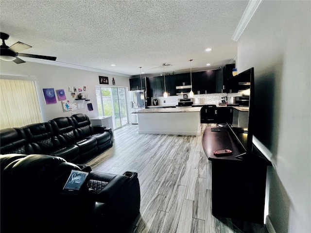 living room featuring a textured ceiling, ceiling fan, light wood-type flooring, and crown molding